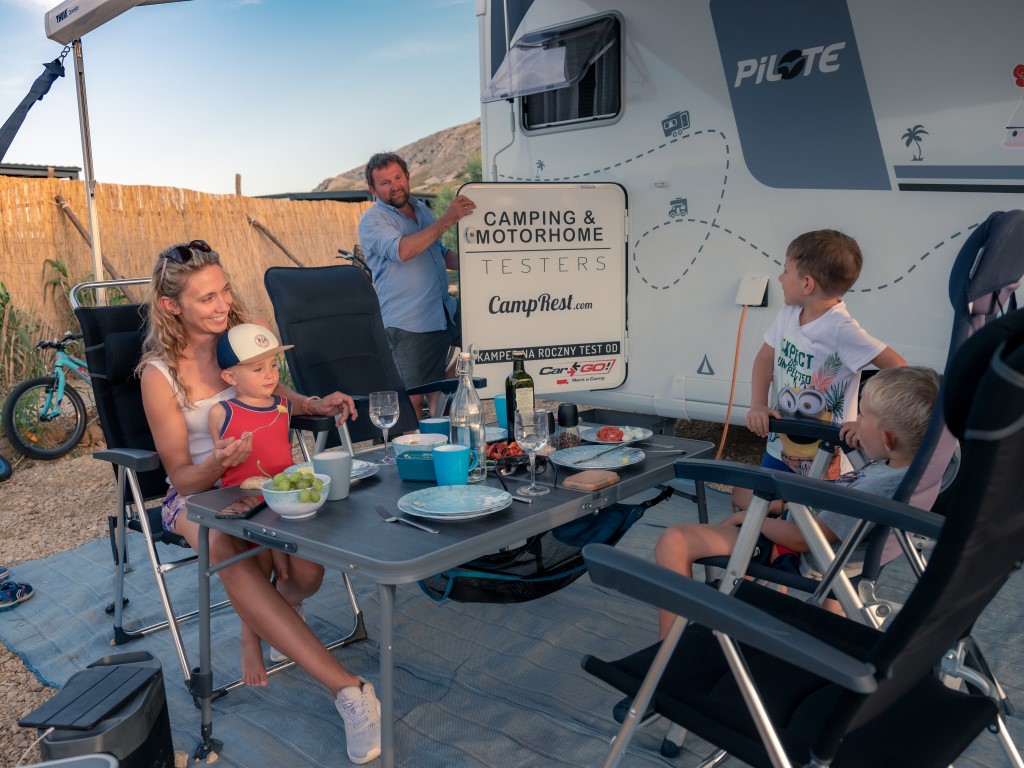 Family at the table in front of the camper