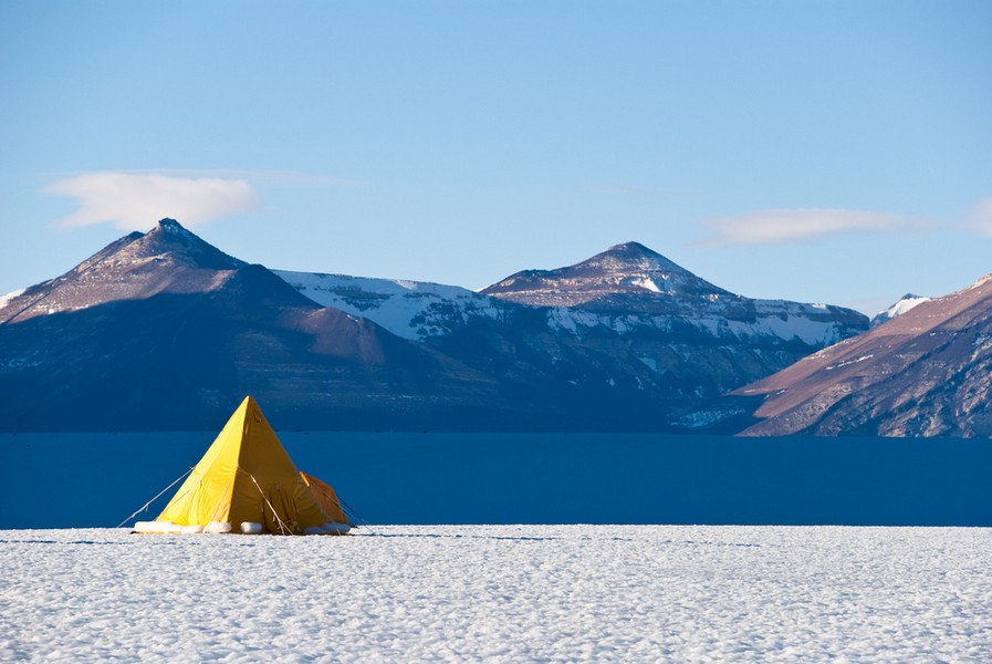 A tent covered with snow, i.e. a camping in winter – main image